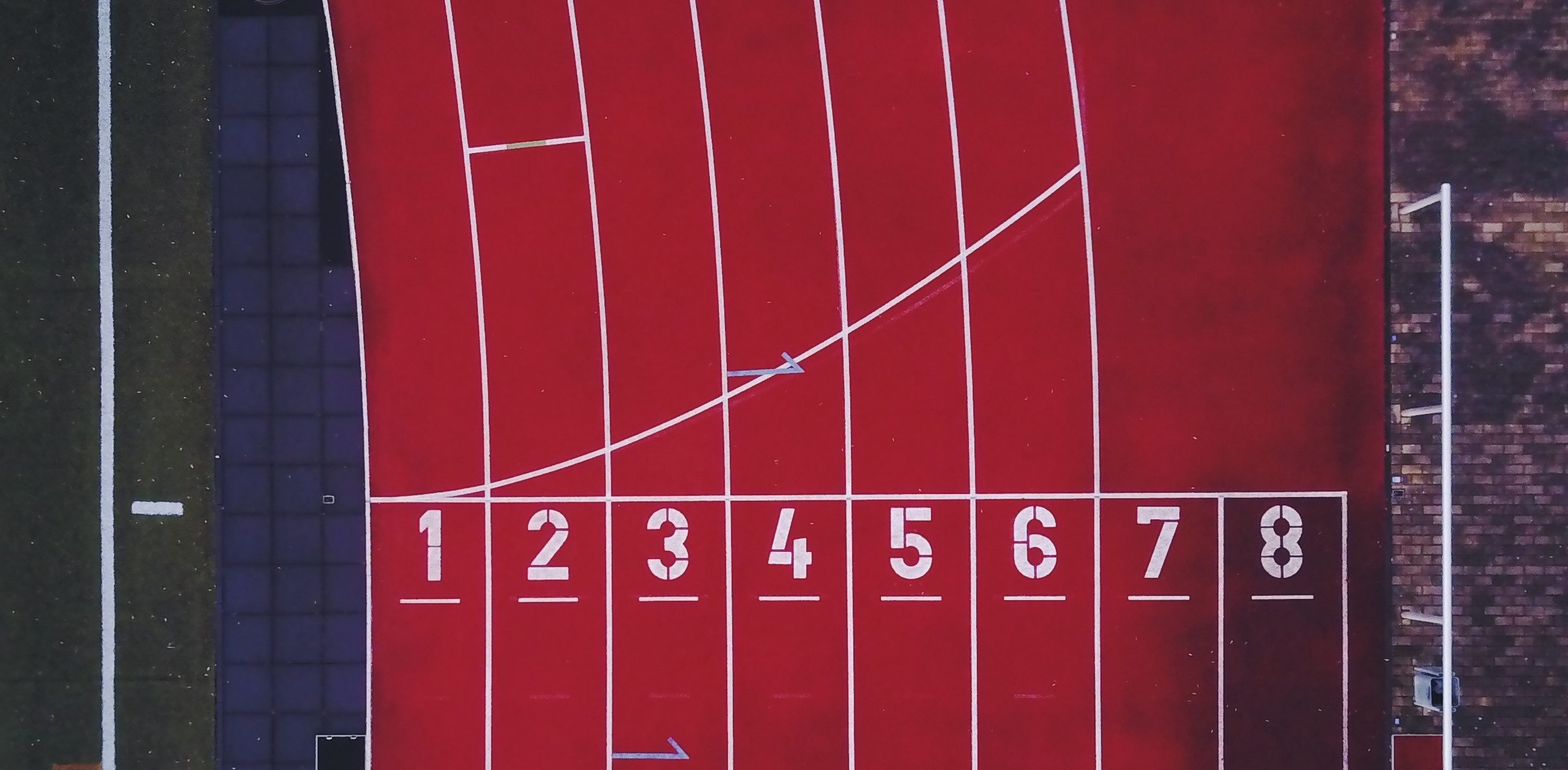 Top-down photo of the numbered lanes on a running track
